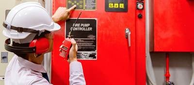 An inspector looks at a fire pump